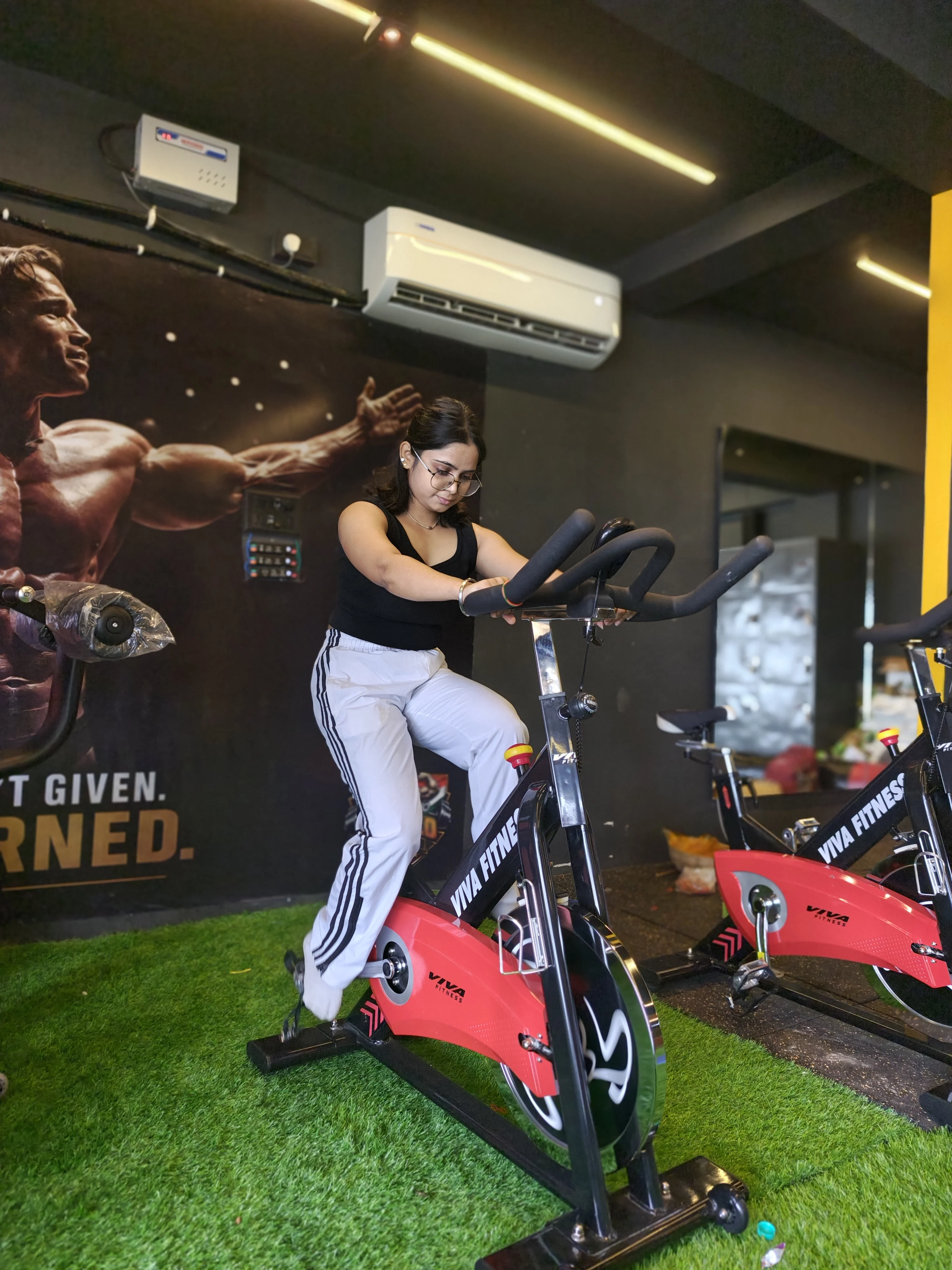 Treadmill and spin bikes in the cardio zone at Arnold Gym